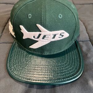 Green New York Jets leather strap hat